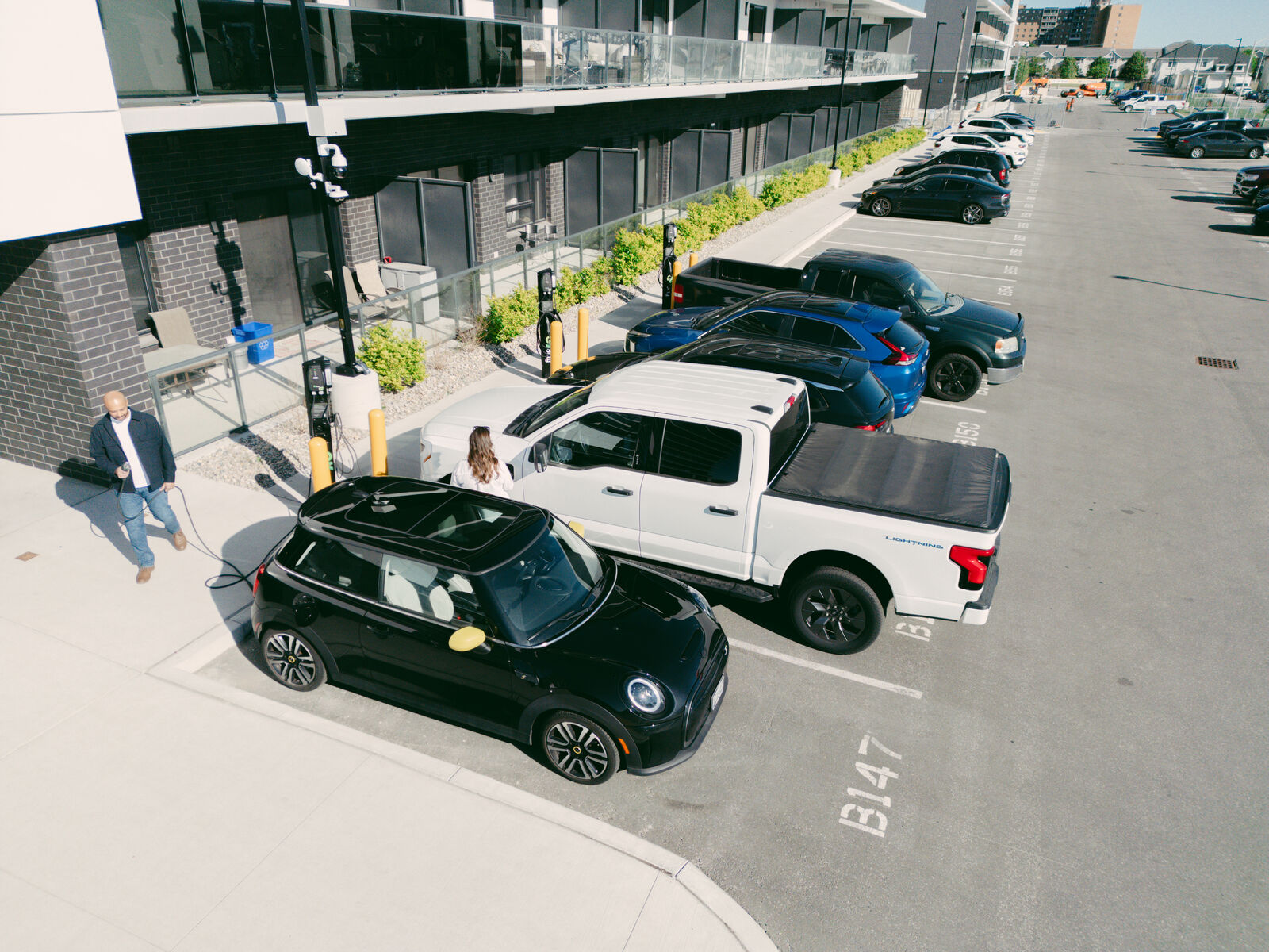 Aerial view of EV charging stations at a multi-unit residential development in Windsor-Essex