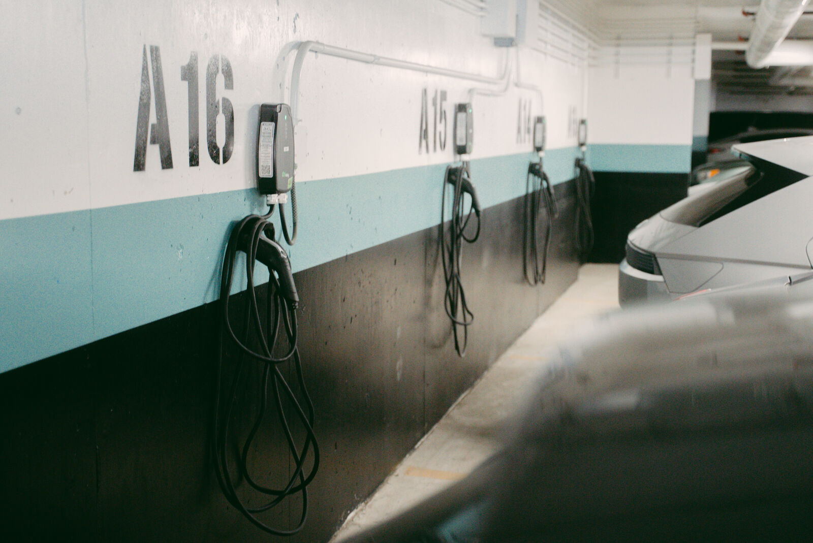 Wall-mounted EV chargers in Damask Apartments underground garage