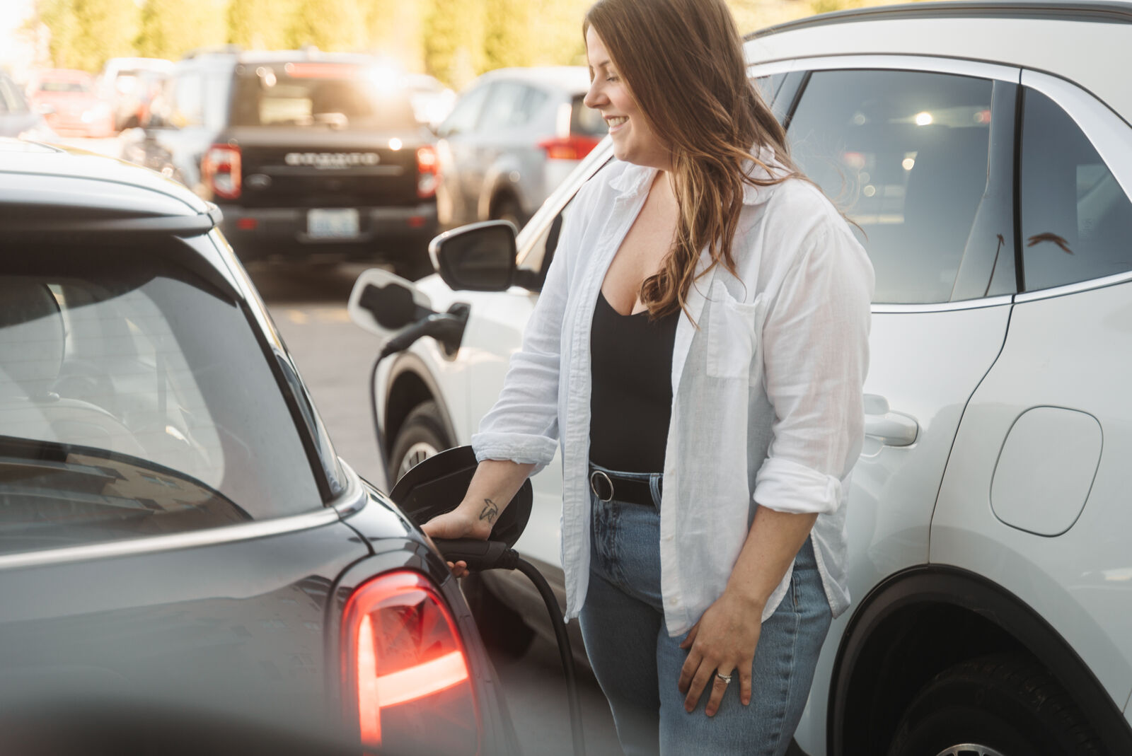 Nicole Lokanath, founder of Taurean EV, plugging in an EV charger