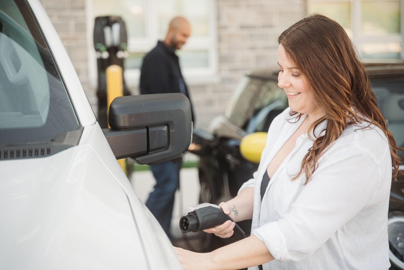 Customer plugging in EV charger